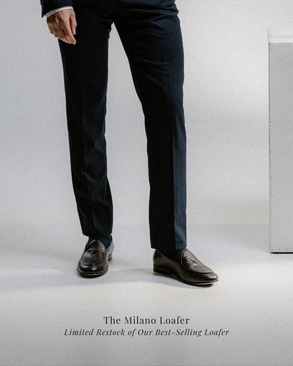 man wearing dress pants and dark leather loafers with dress socks