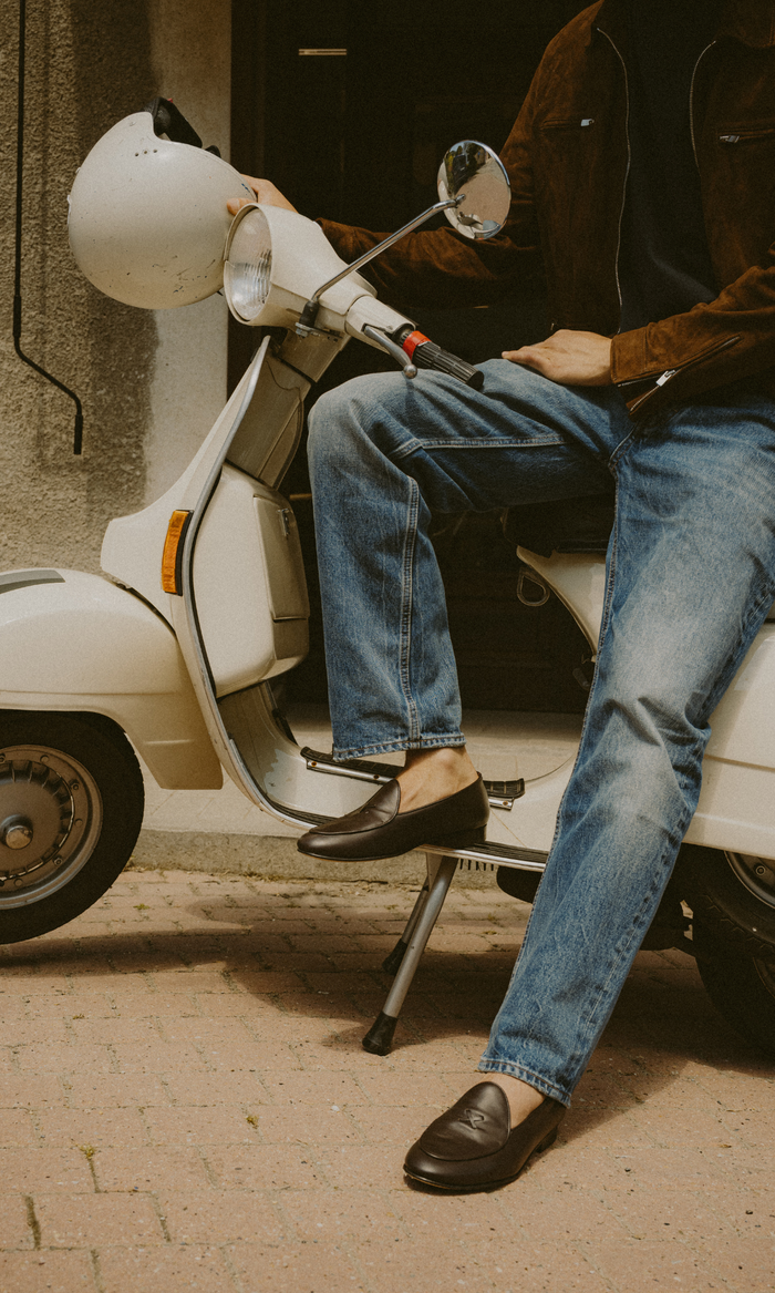 Man on motorcycle wearing dark brown leather loafers