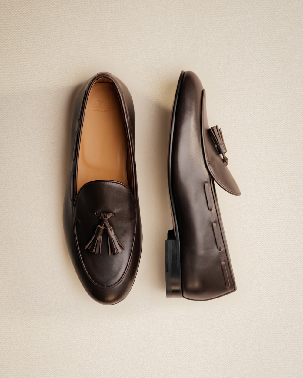 dark brown leather loafers with leather tassel on front vamp